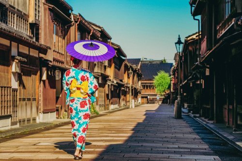 Geisha Walks Through The Streets Of Takayama Japan