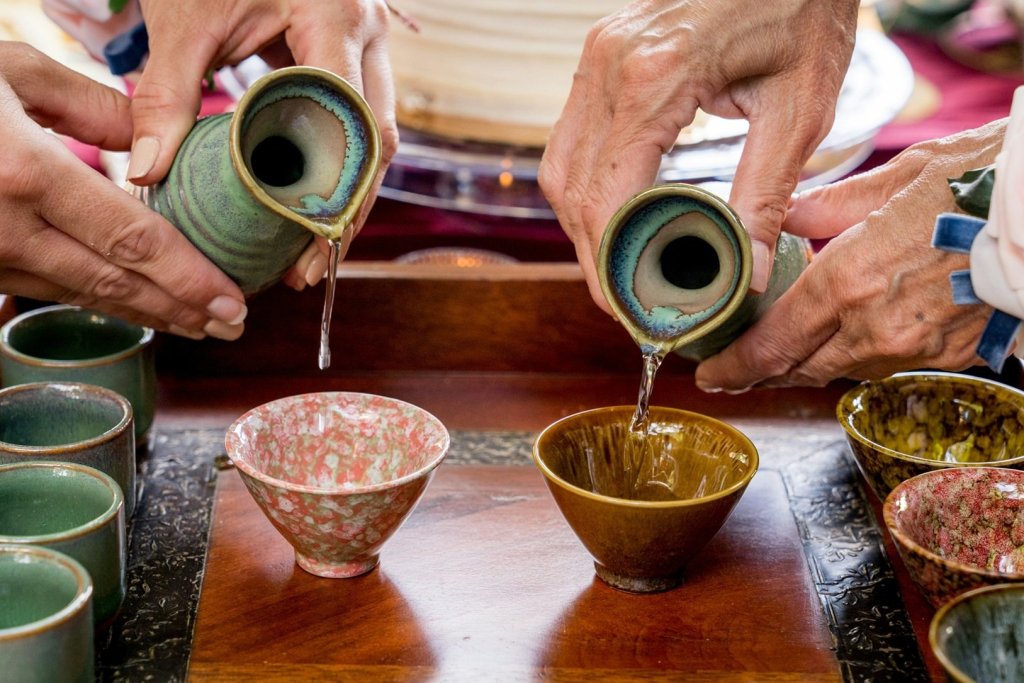 Japanese Sake Being Poured Into Yunomi Cups